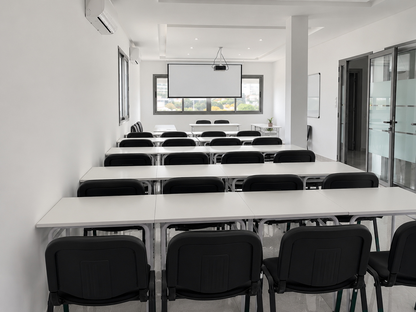 Empty 1337 Academy classroom with orderly desks and black chairs